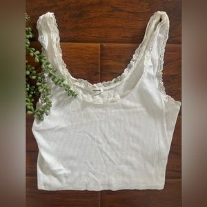 Cute white top embroidered around the neckline.